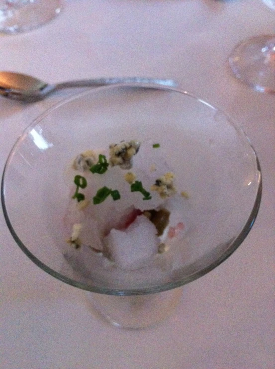 the dessert in the glass is garnished with herbs
