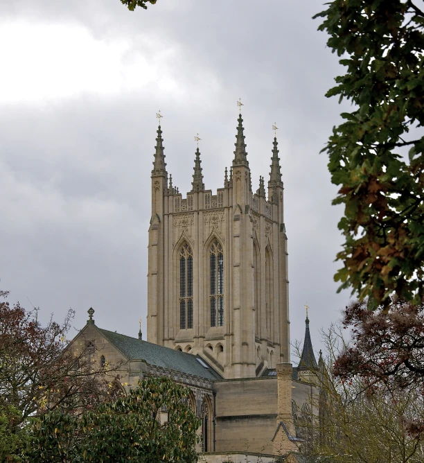 a large stone church with towers in a cloudy sky