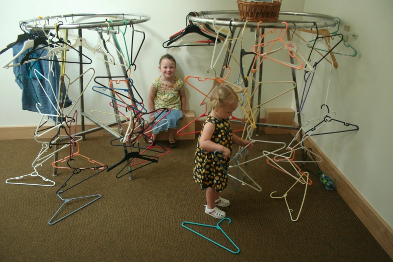 two young children play with sticks and magnets