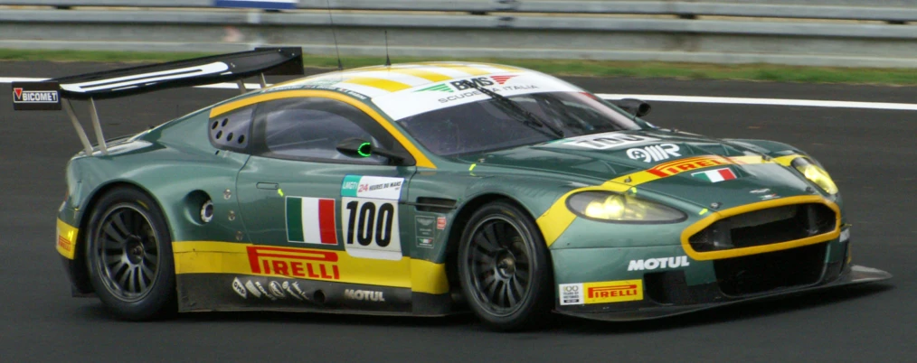 a green and yellow car driving on the race track