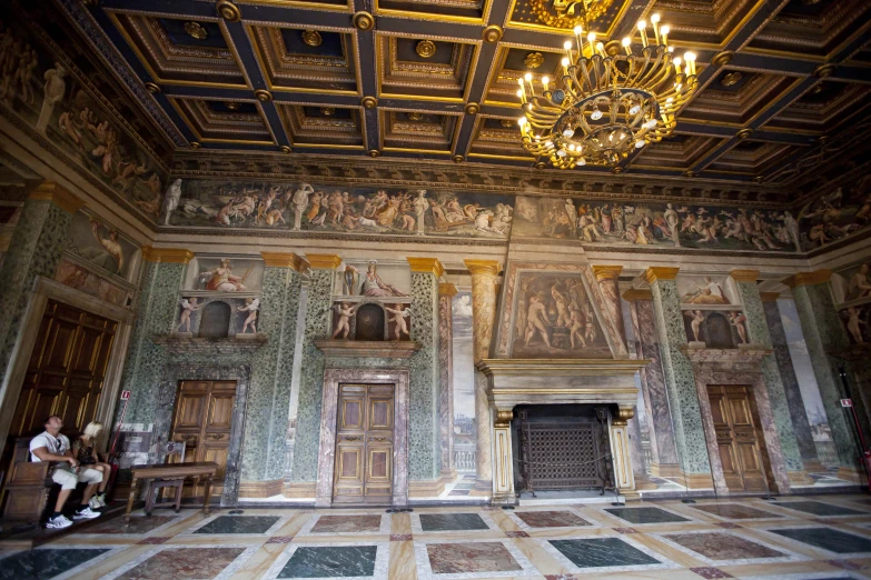 a large room with many paintings on the walls