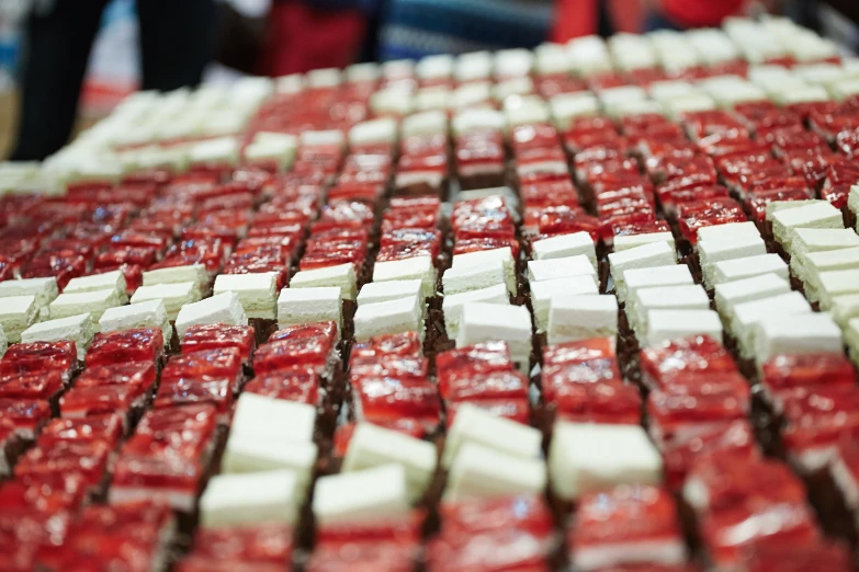 the pieces of white and red food are sitting on a table