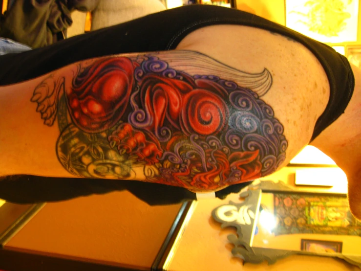 a man with a colorful tattoo design on his shoulder