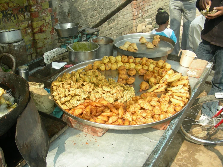 a man preparing food at an outdoor marketplace