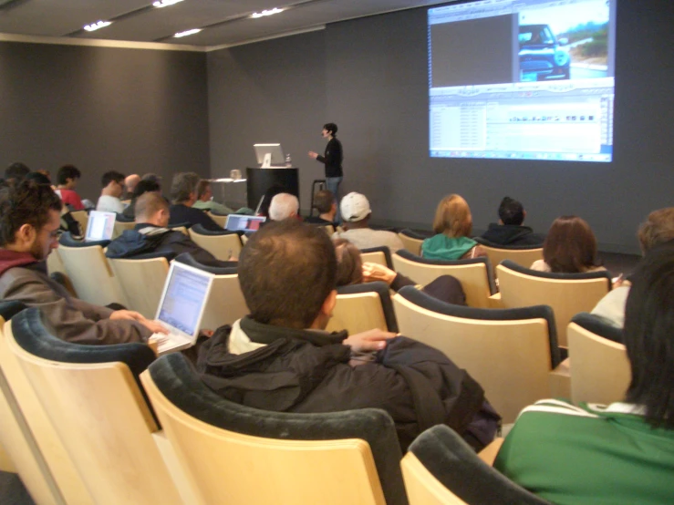 there is an audience watching a video in the auditorium