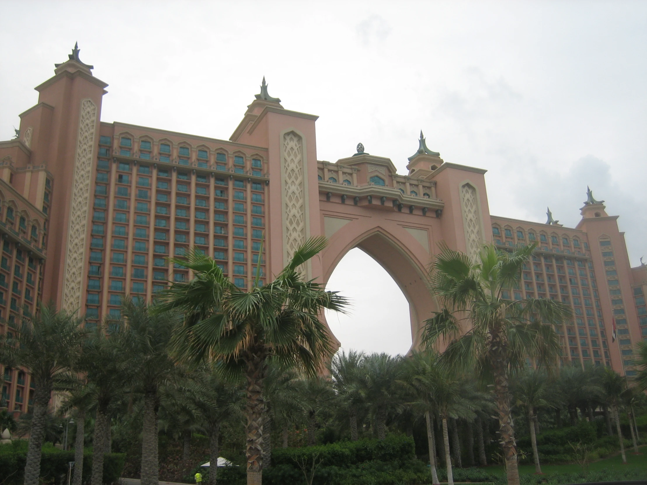 several palm trees outside of a large building