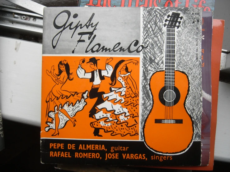 there are two books with an image of an orange guitar