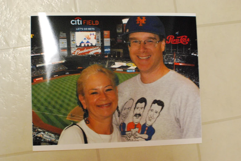 a man and woman taking a po at a baseball game