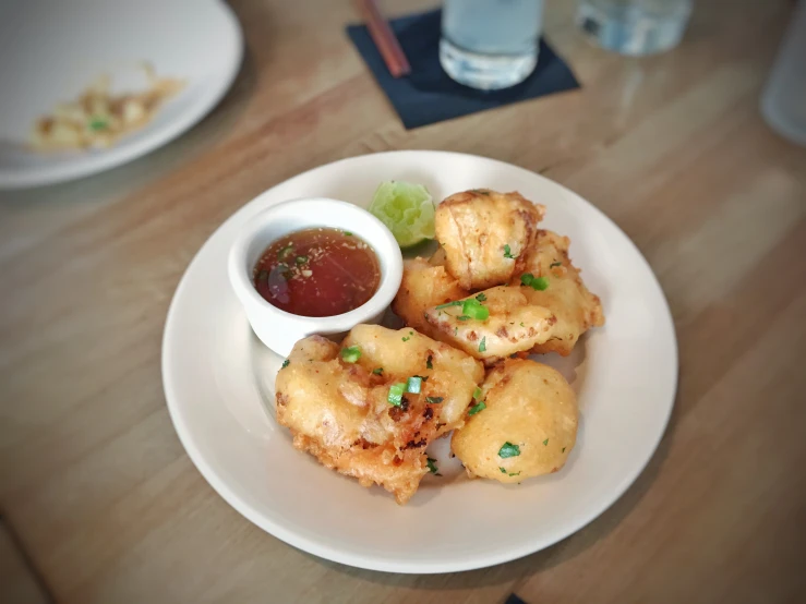 some food and a dipping sauce on a plate