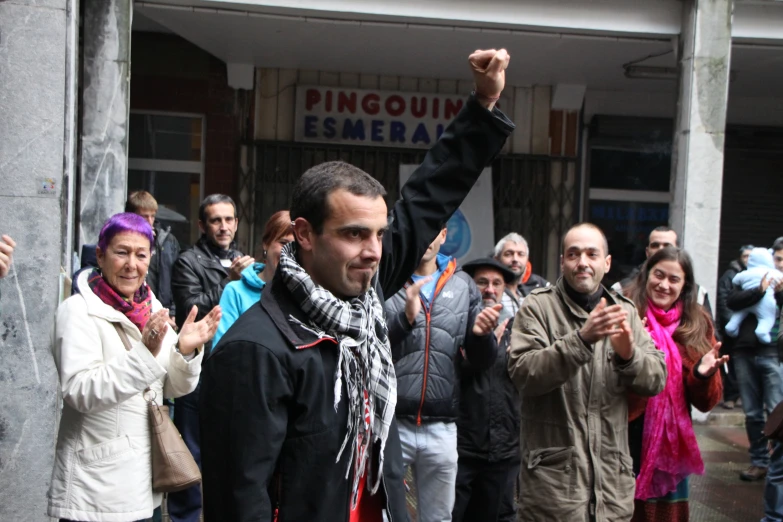 a large group of people stand in front of a building