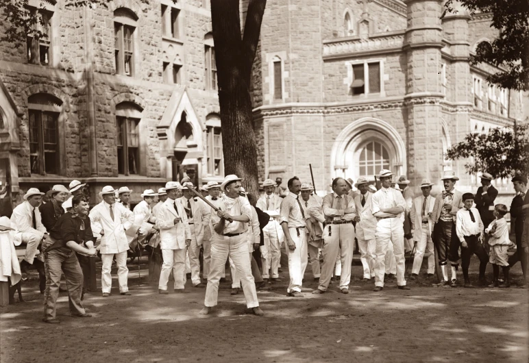 many men stand with guns and are standing in front of a castle