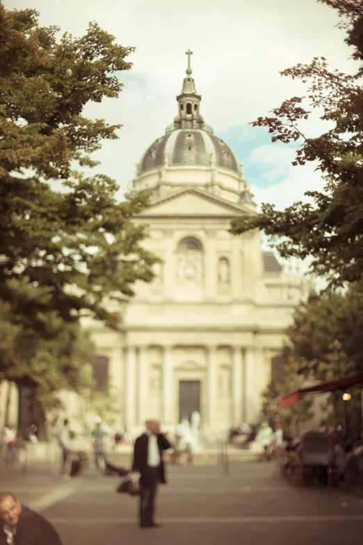 a building with a domed steeple with trees around it