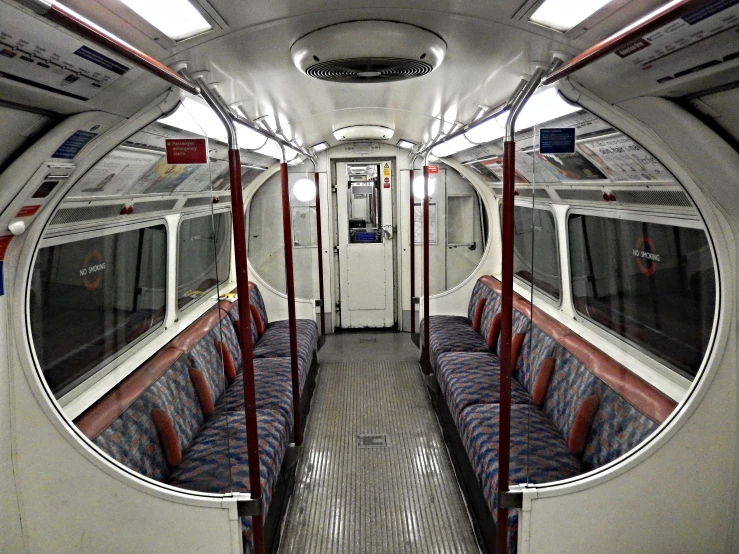 an empty subway train with seats down