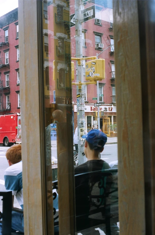 a person is sitting on a bench looking in the window