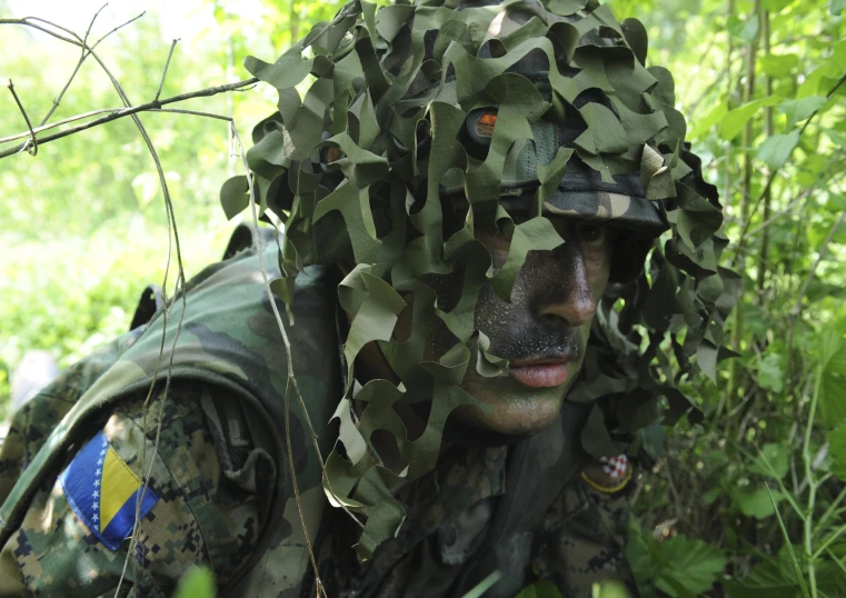 a soldier is in the woods covered in ivy