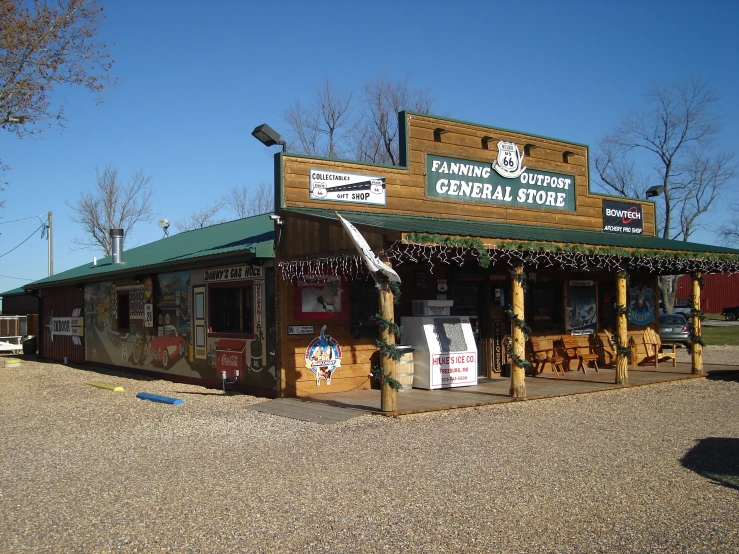 a store front with wooden columns in the middle of the road