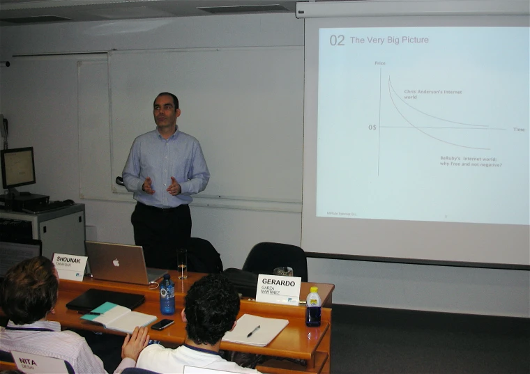 man giving a lecture in front of large group of people