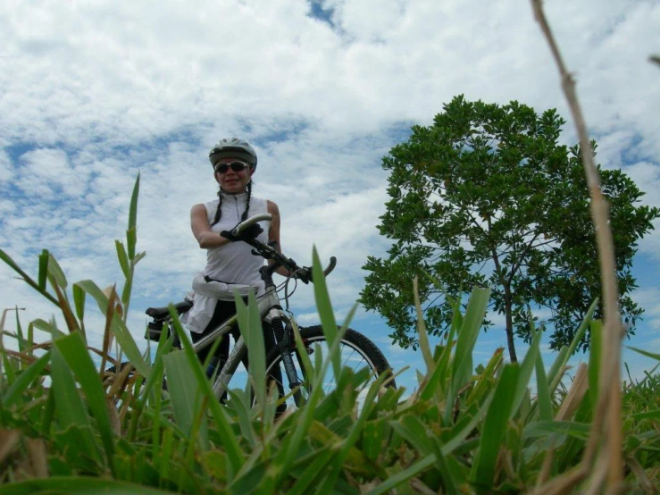 a young man riding a bike through the grass