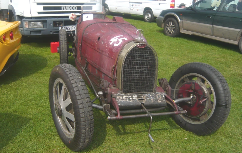 a very old fashioned car on display at a show