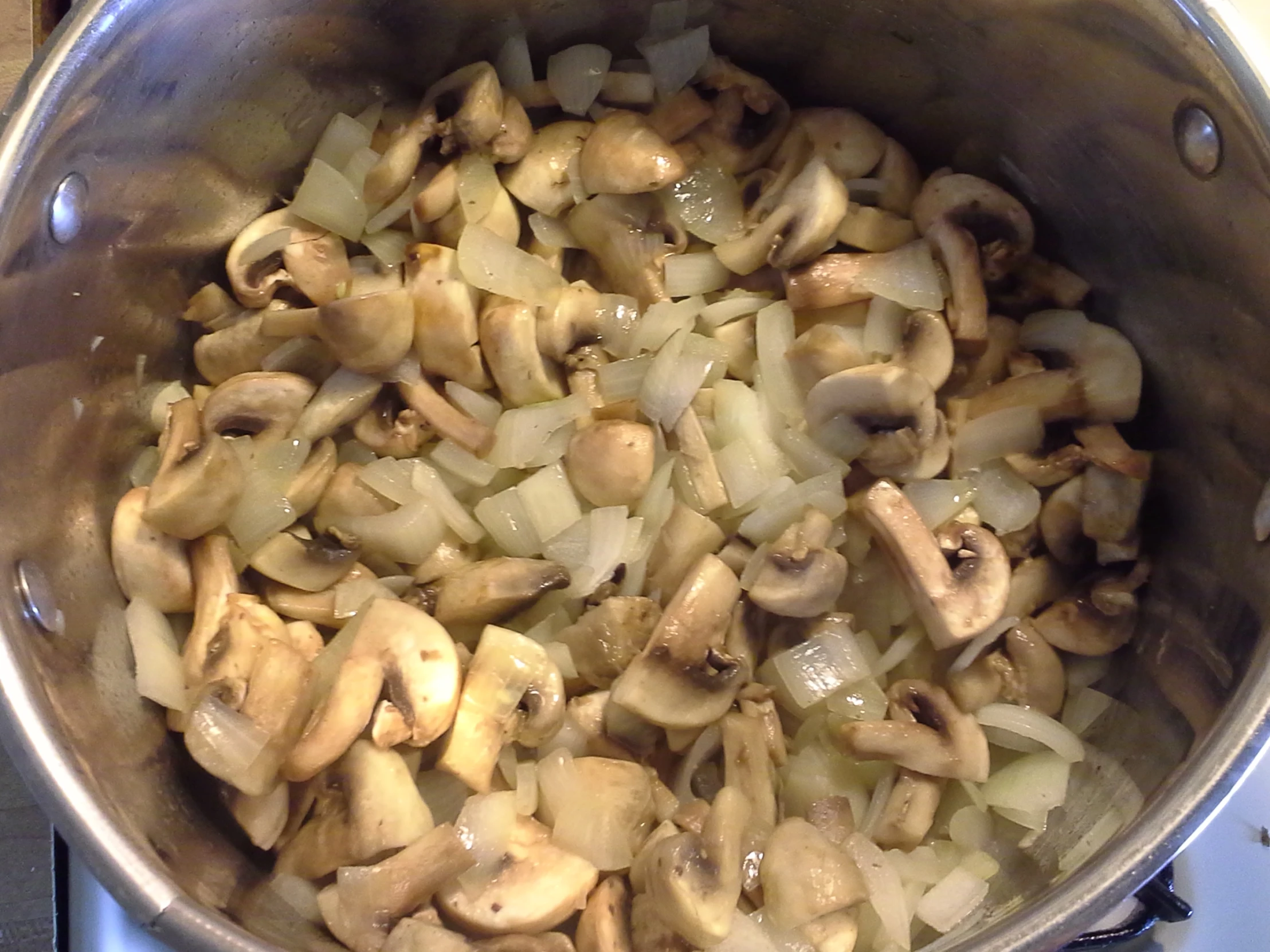 the cooked mushrooms are cooking in a pot