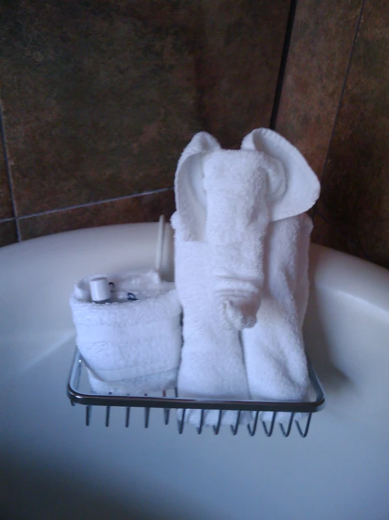 a bath room with a tub and towels