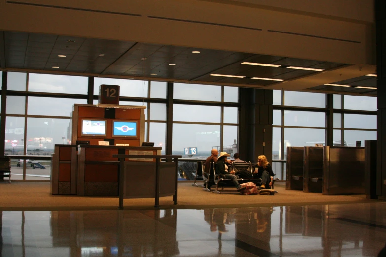 an airport lobby with large windows overlooking the terminal