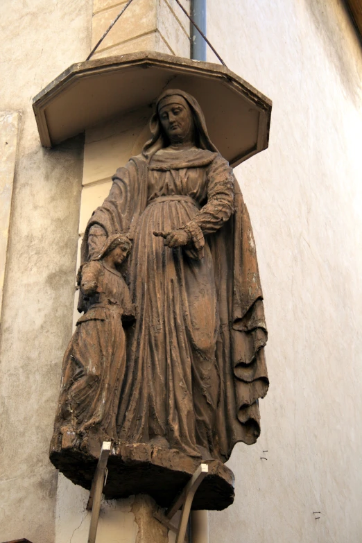 a statue stands in front of a building