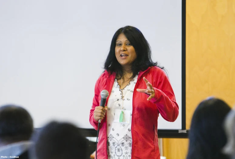 a woman giving a presentation with a microphone