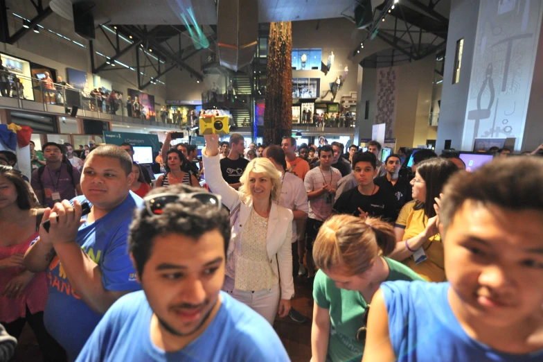 group of people standing in line with cell phones