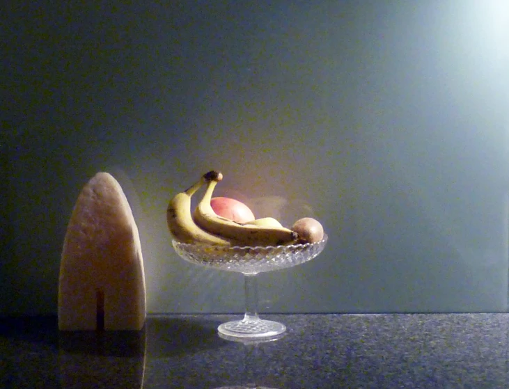 a small glass bowl with bananas on top of a table