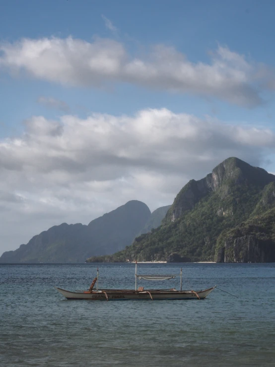 a man riding on the back of a boat on top of a large body of water