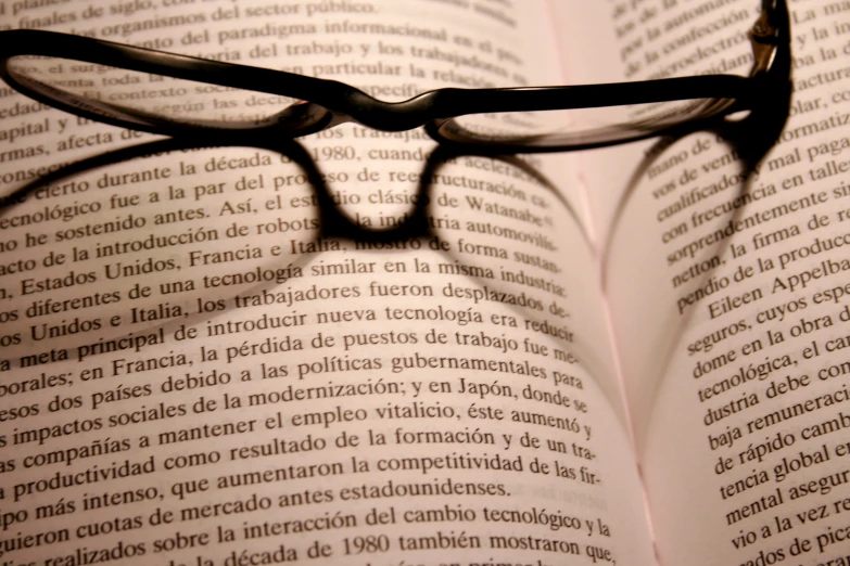 an image of glasses on the book with the page
