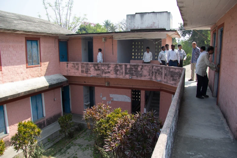 several people are standing outside an apartment building