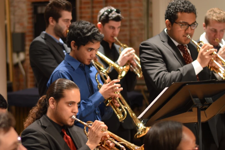 a orchestra member in the audience plays a variety of instruments