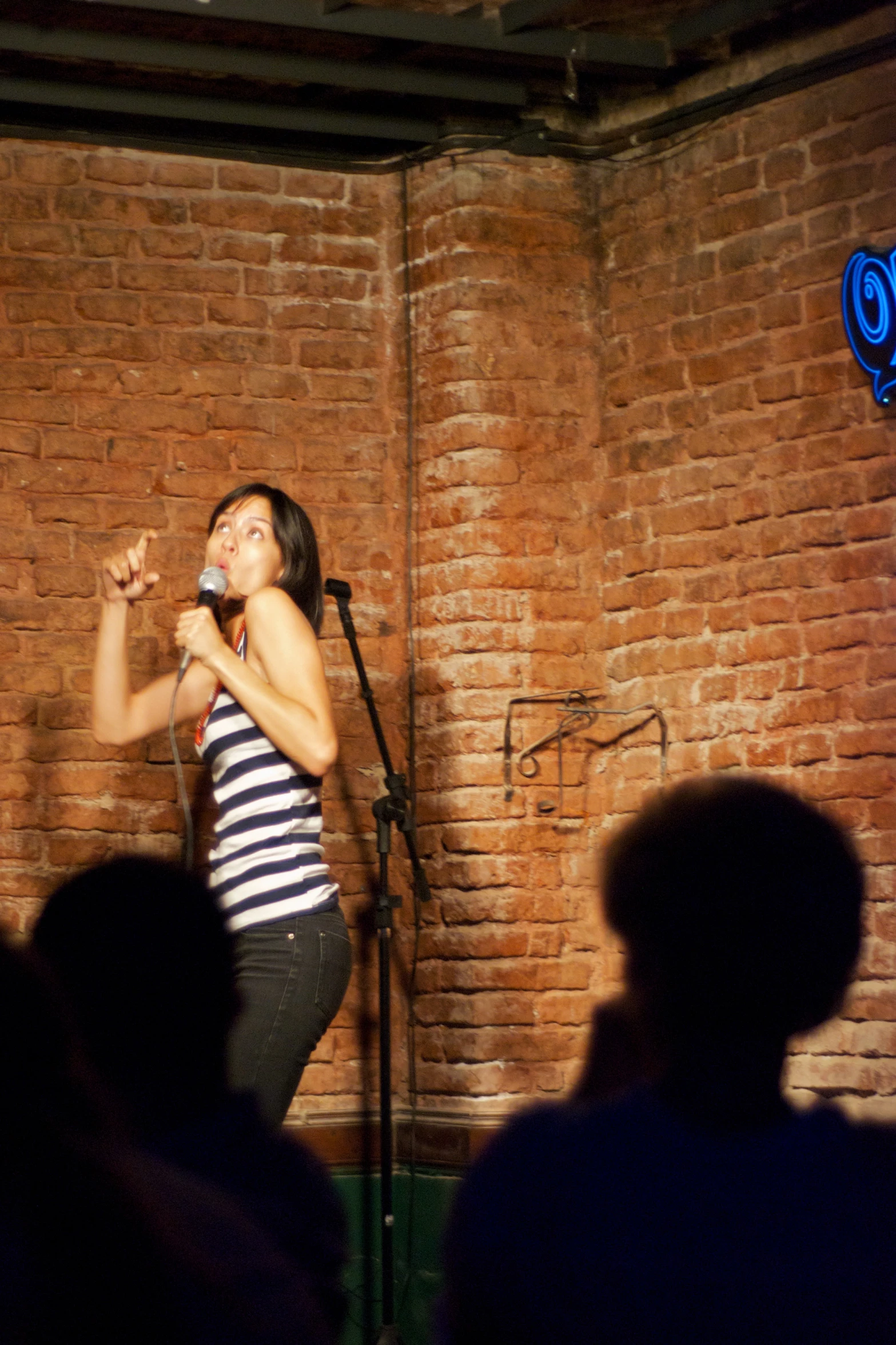 a woman standing in front of a microphone