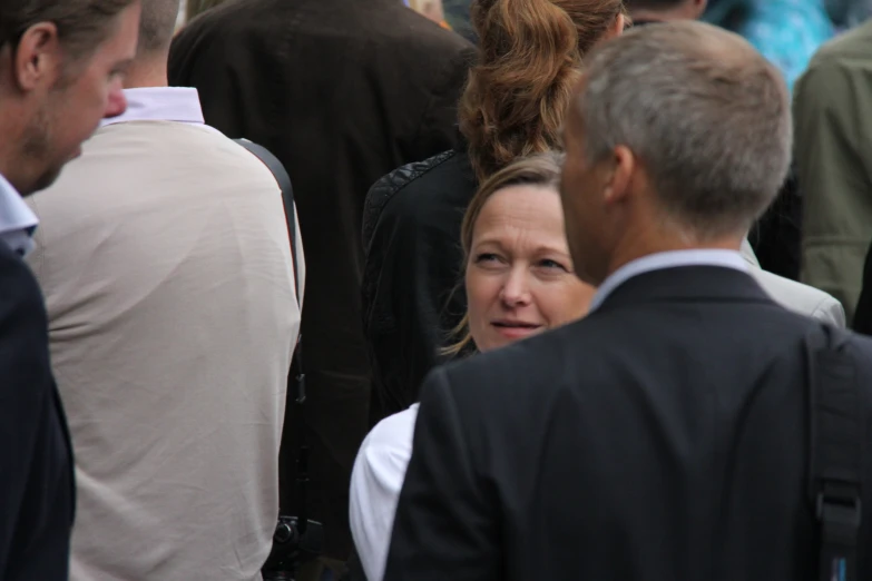 a woman and man walking together among people