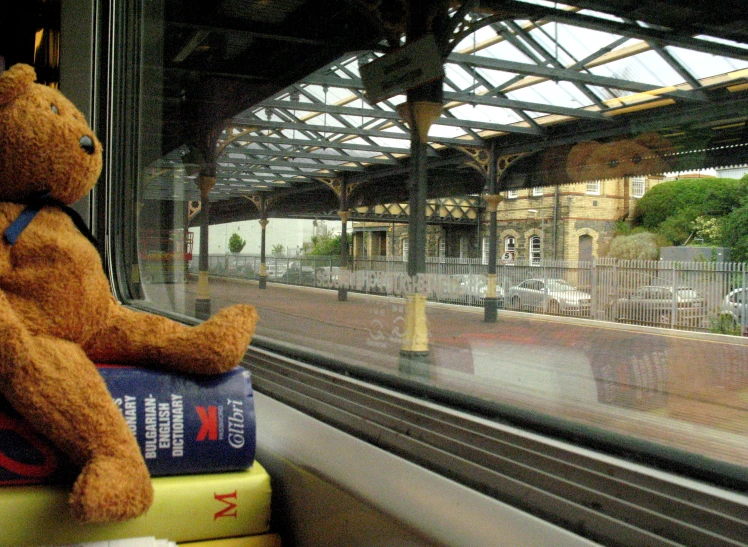 a teddy bear that is sitting on a book