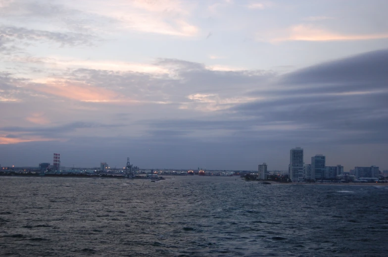 the ocean near a skyline that appears to be full of buildings