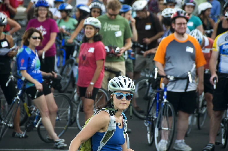 a woman is wearing a helmet and carrying her backpack