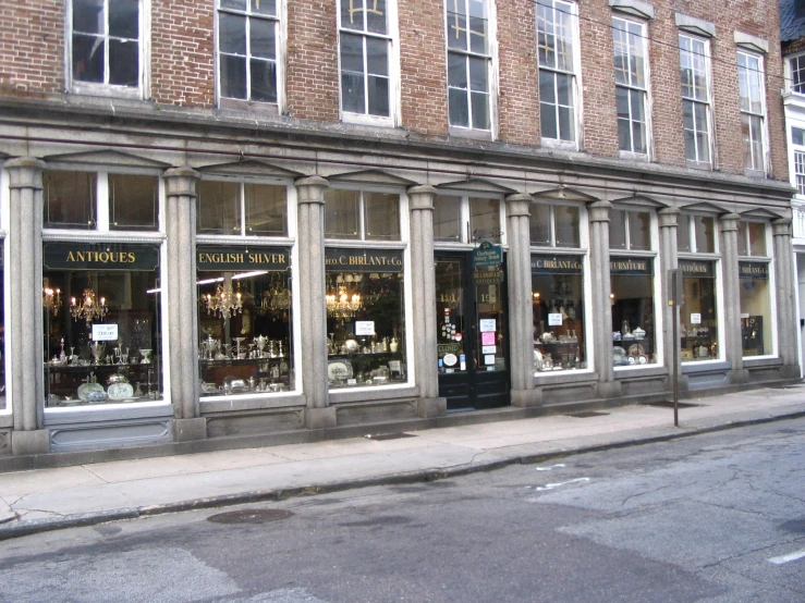 an empty street corner with stores windows and some shops