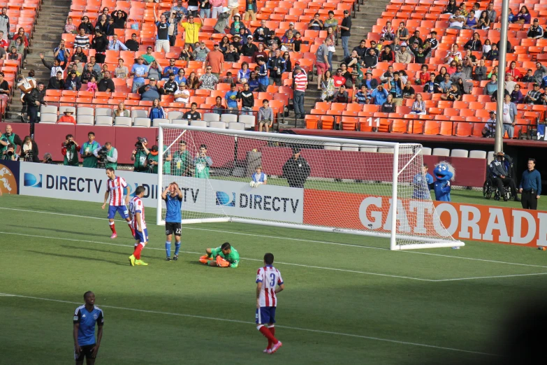 soccer players standing on field during match in stadium