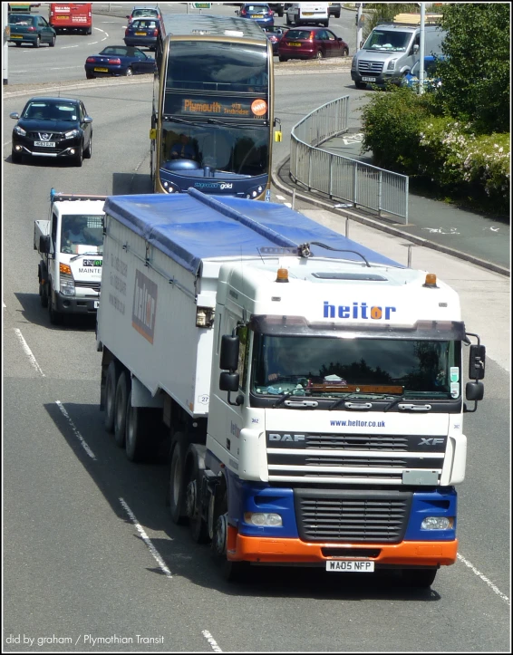 trucks move down a busy city road in heavy traffic