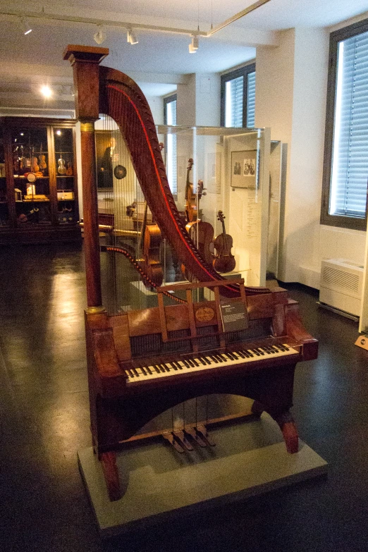 an organ in a museum sitting on top of a wooden floor