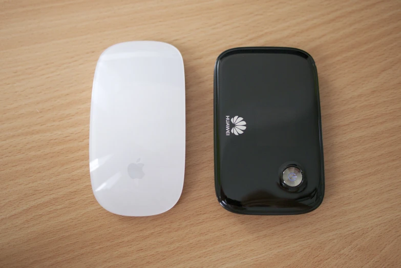 an iphone and its front cover, facing each other on a wooden table