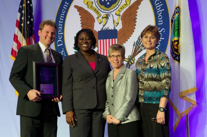 five business people standing and posing for a po