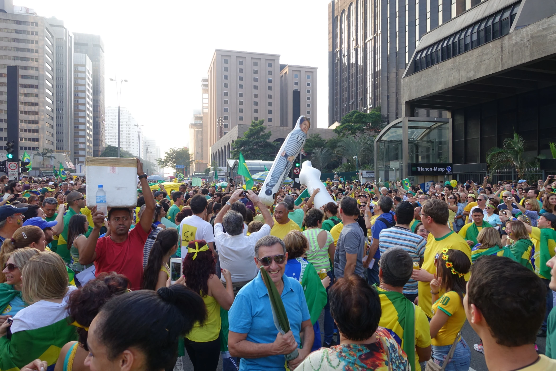 people stand outside in a city and are holding flags