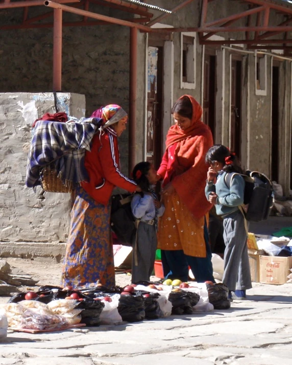 two women standing with bags on the street