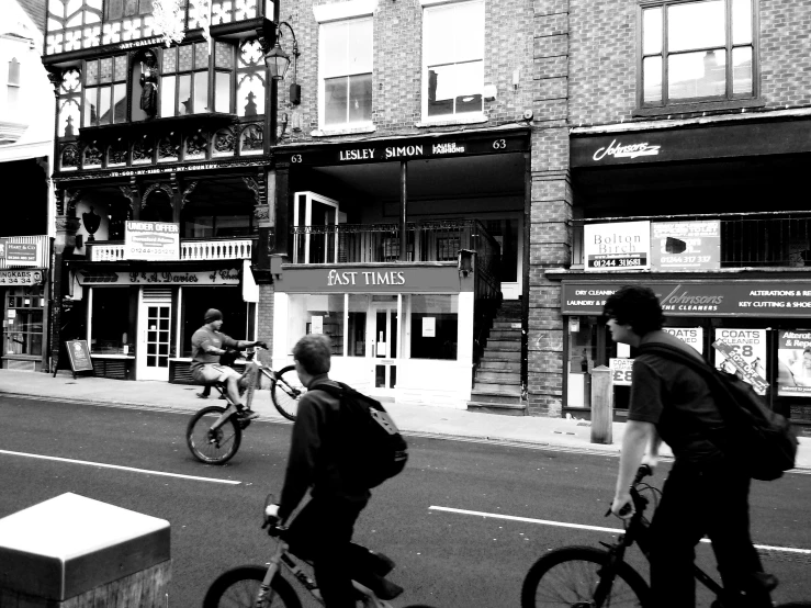 black and white picture of bikers on a busy road