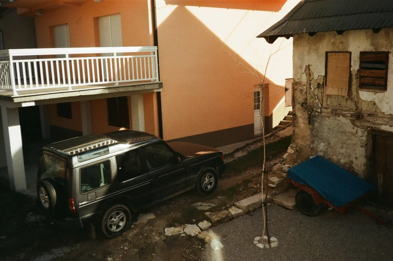 an suv that is parked next to a house