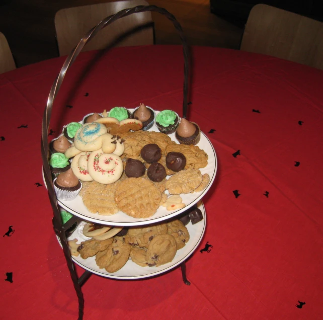 two dishes filled with cookie treats sitting on top of a red table